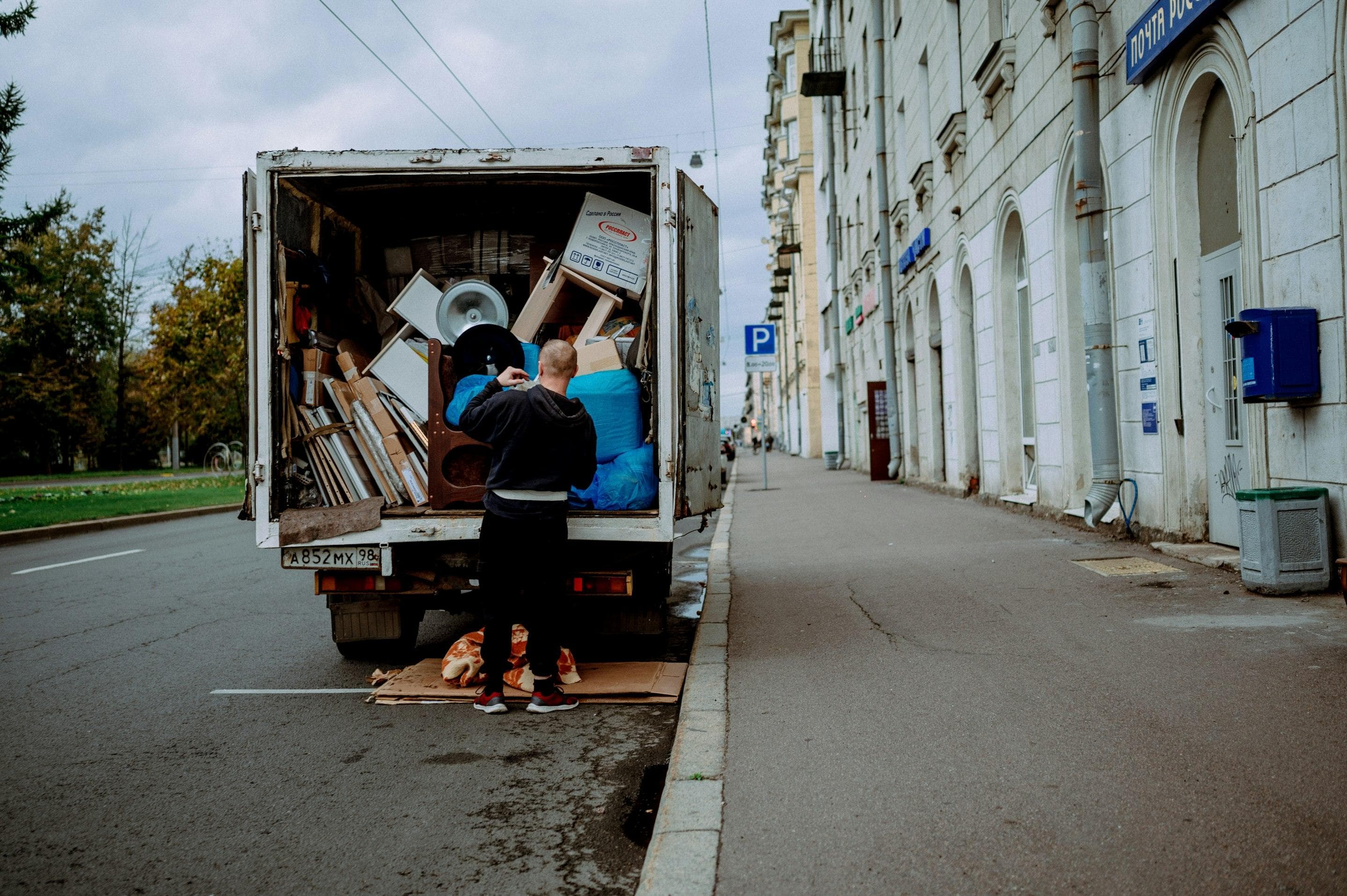 Person loading furniture into an unmarked moving truck